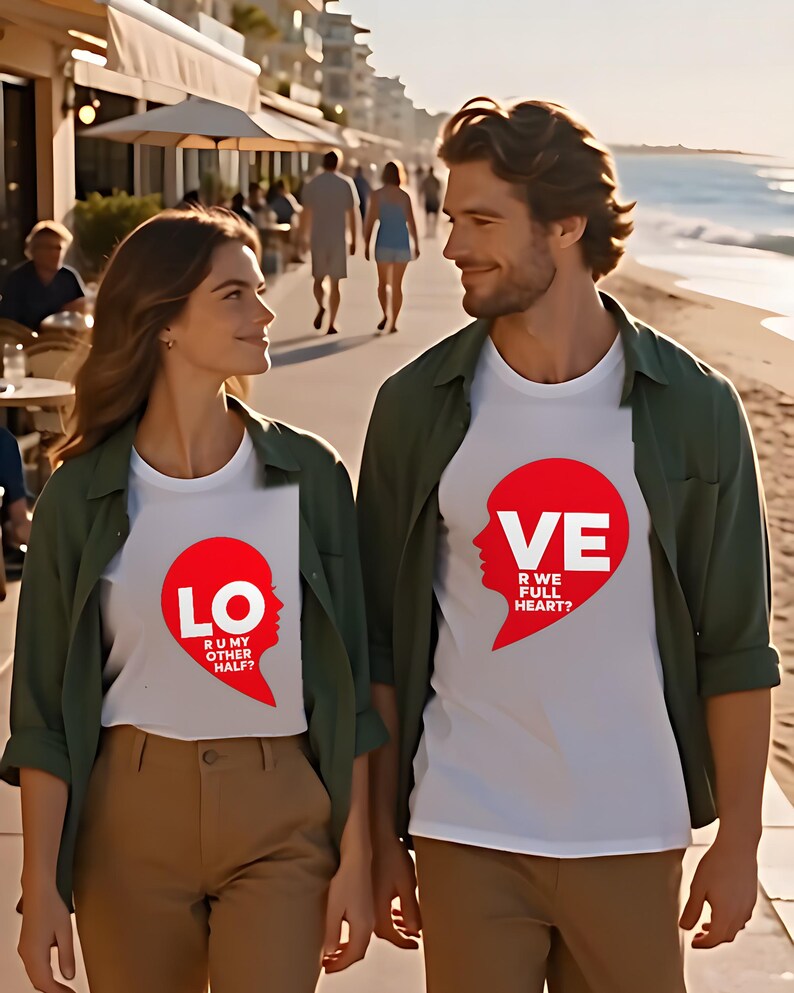 Couple walking on a beach promenade wearing matching LO and VE half heart shirts