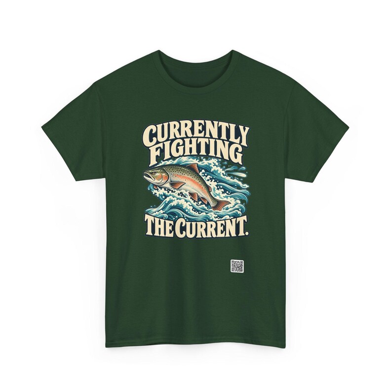 May include: A dark green t-shirt featuring a graphic of a fish jumping through blue and white waves. The text above the fish reads CURRENTLY FIGHTING and the text below reads THE CURRENT. A small white square QR code is printed near the bottom.