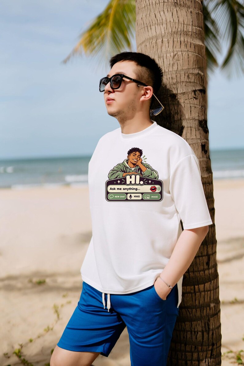 May include: A white short-sleeved t-shirt featuring a graphic print of a person resting their chin on their hand above a chat interface box with the text HI. Ask me anything, New Chat, Voice, and Image icons in black, green, and white.