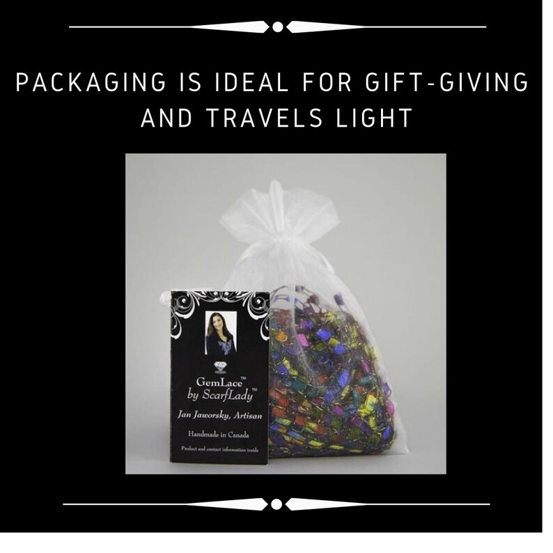 May include: A white organza bag with a colorful, patterned scarf inside. The bag is labeled with a business card that reads "GemLace by ScarfLady, Jan Jaworsky, Artisan, Handmade in Canada."