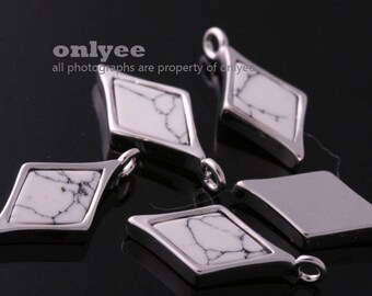 May include: Five silver diamond-shaped pendants with white marble-like inlays. The pendants have a smooth, polished finish and are perfect for adding a touch of elegance to any jewelry project.