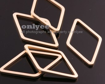 May include: Five gold-colored metal diamond-shaped rings. The rings are stacked on top of each other.