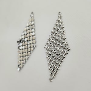 May include: Two silver chain earrings, one with a diamond shape and the other with a teardrop shape.