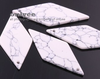 May include: Four white diamond-shaped pendants with a marbled pattern and a hole at the top for hanging.