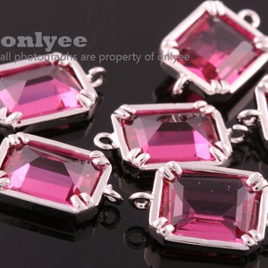 May include: Five pink crystal connector charms with silver settings. Each charm has two loops for attaching to jewelry.