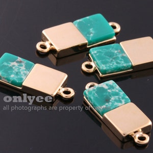 May include: Four gold-toned metal connector pieces with green and white marbled stone accents. Each piece has two loops for attaching to jewelry.