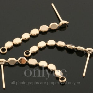 May include: Three gold-toned earring components, each featuring a chain of octagonal-shaped beads with a small loop at one end and a post at the other end.