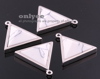 May include: Four silver triangle pendants with white marble inlay. Each pendant has a loop at the top for attaching to a chain or cord.