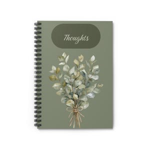 May include: A spiral-bound notebook with a sage green cover featuring a watercolor illustration of a eucalyptus branch bouquet tied with a string. The word Thoughts is printed in a white script font inside a dark olive green oval shape.