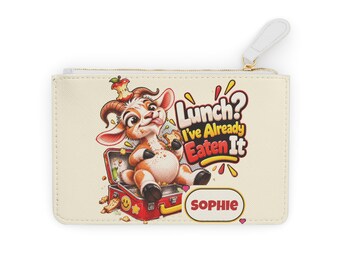 May include: A cream-coloured rectangular zipped pouch featuring a cartoon goat sitting in a red lunchbox. The text reads "Lunch? I've Already Eaten It" and "SOPHIE" in a white oval. The goat has brown and white fur and a half-eaten apple on its head.