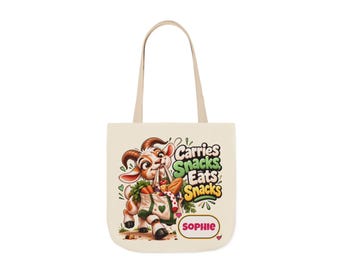 May include: A cream-colored canvas tote bag featuring a cartoon goat carrying a grocery bag filled with vegetables. The text reads Carries Snacks Eats Snacks and the name SOPHIE in a rectangular box. The design includes small green hearts.