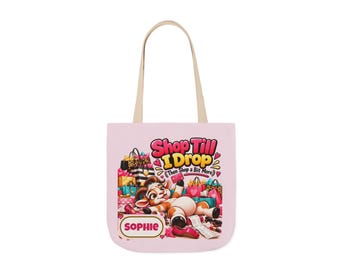May include: A light pink tote bag with beige handles featuring a cartoon goat lying amidst colorful shopping bags and accessories. The text reads Shop Till I Drop (Then Shop a Bit More) and the name SOPHIE is printed in a white rectangular box.