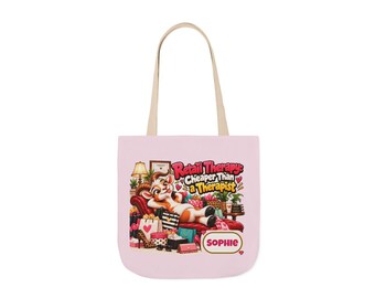 May include: A light pink tote bag with two beige handles featuring a cartoon cow lounging on a red sofa surrounded by shopping bags and the text Retail Therapy: Cheaper Than a Therapist and the name Sophie in a white oval frame at the bottom.