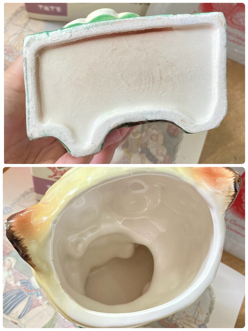 May include: A vintage ceramic planter, featuring a cream-colored interior and a light green and yellow exterior. The planter has a rectangular base with a curved design and a detailed top. The interior is smooth, while the exterior has a textured finish.