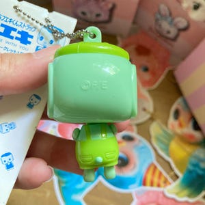 May include: A white ceramic mug with a black handle and the text "But First, Coffee" in a handwritten style. The mug is likely 11-15 ounces, suitable for hot beverages.