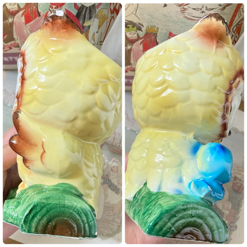 May include: A vintage ceramic owl figurine with a yellow body, brown accents, and a blue and green base. The owl is perched on a green tree trunk. The figurine has a glossy finish and detailed feather textures.