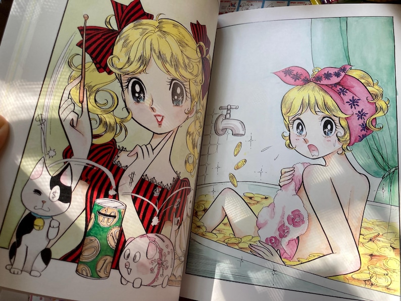 May include: A colorful manga illustration depicts a young woman with blonde hair, red bows, and a red and black striped dress. A cat with a dollar sign on its eye and a piggy bank are also shown. The second image shows a woman in a bathtub filled with coins.