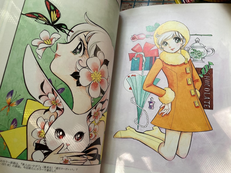 May include: A colorful illustration from a book featuring a woman with flowers and a rabbit, and a girl in an orange coat. The girl is kneeling next to a chocolate bar, gifts, and a teapot. The illustration is in a manga style.