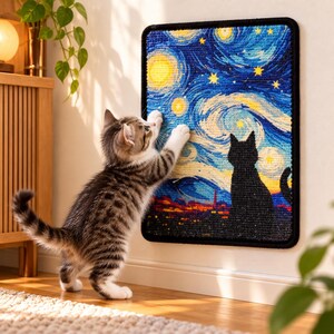 May include: A rectangular cat scratching pad mounted on a wall, featuring a textured, colorful print of a starry night sky with swirling blue patterns, yellow stars, and a black silhouette of a cat sitting in the foreground.