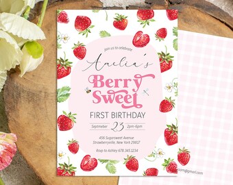 May include: A birthday invitation with a strawberry theme. The invitation features the text "Amelia's Berry Sweet First Birthday" with strawberry illustrations. A second card with a pink gingham pattern is also visible.