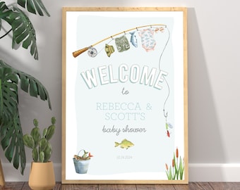 Op de afbeelding: Een lichtblauw welkomsbord met een hengel en babykleding die eraan hangen. De tekst op het bord luidt "Welkom bij Rebecca & Scott's babyshower".