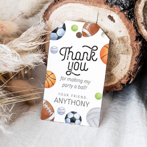May include: White thank you tag with a colorful sports ball design. The text reads "Thank you for making my party a ball! Your friend, Anthony."