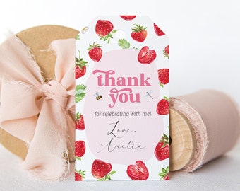 May include: White thank you tag with a pink and white strawberry pattern. The tag says "thank you" in pink letters and "for celebrating with me!" in black letters. The tag also says "Love, Amelia" in pink letters.