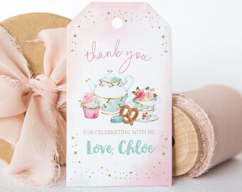 May include: A rectangular gift tag with a pink watercolor gradient background and gold star accents. The tag features a watercolor illustration of a teapot, teacup, cupcake, pretzel, and macaron. Text reads: thank you FOR CELEBRATING WITH ME Love, Chloe.