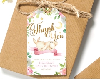 May include: A white thank you tag with a sleeping bunny, pink ribbon, and floral border. The text "Thank You" is in gold script. The tag says "Showering us with love! Melissa's Baby Shower 04.20.2021".