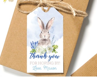 May include: A blue and white thank you tag with a watercolor illustration of a bunny rabbit surrounded by flowers. The text reads "Thank you for hopping by! Love, Maxon".
