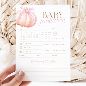 May include: A baby shower prediction card with a watercolor pumpkin and pink bow. The card includes sections for date, time, gender, weight, length, hair, eyes, and name. Text reads "Baby Predictions" and "Advice and Wishes".
