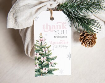 May include: Pink and white thank you tag with a watercolor illustration of a Christmas tree with pink bows. The text reads "Thank You for celebrating Amanda's first birthday."