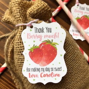May include: A burlap favor bag with a thank you tag that says "Thank You Berry Much!" with a strawberry illustration. The tag also says "for making my day so sweet Love, Caroline".