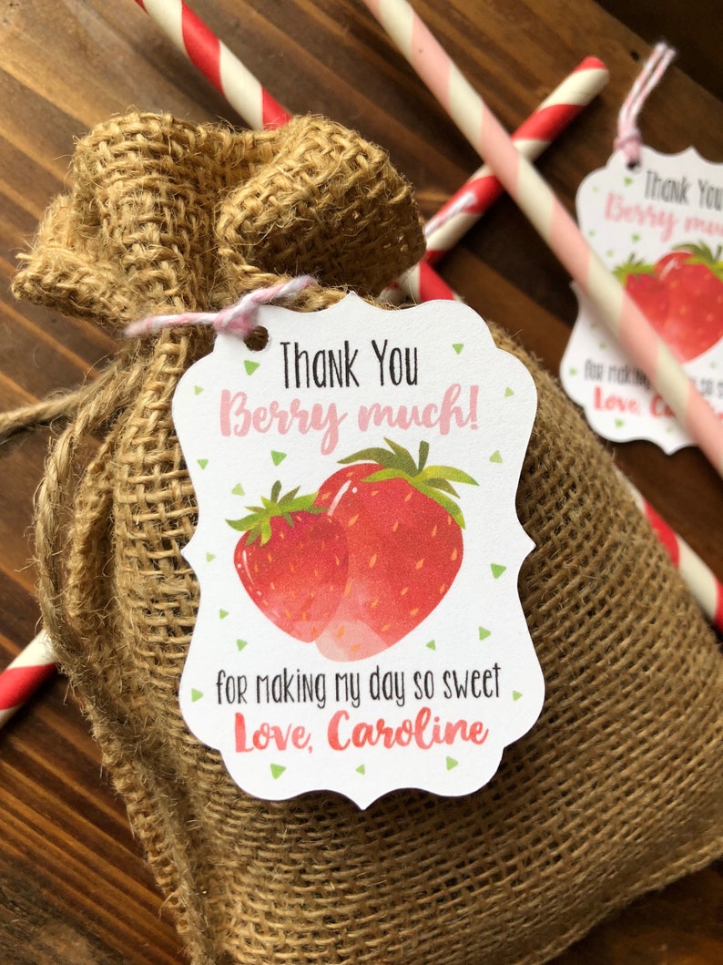 May include: A burlap favor bag with a thank you tag that says "Thank You Berry Much!" with a strawberry illustration. The tag also says "for making my day so sweet Love, Caroline".