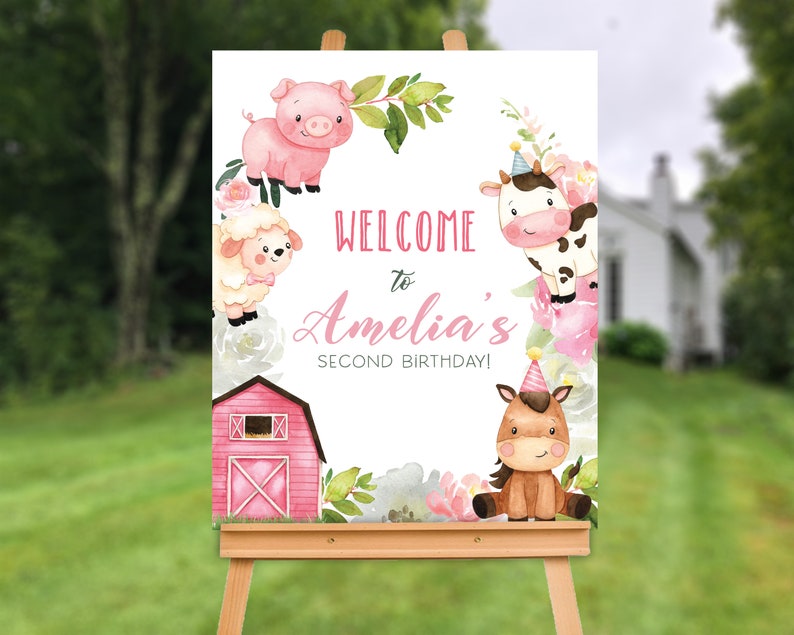 May include: A rectangular welcome sign featuring watercolour illustrations of a pink pig, a white sheep, a black and white cow, and a brown horse, all decorated with pink flowers and a red barn. The text reads: WELCOME to Amelia's SECOND BIRTHDAY!