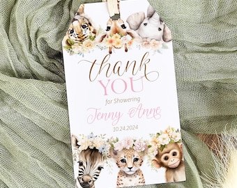 May include: White gift tag with a cream-colored string, featuring watercolor illustrations of a tiger, giraffe, elephant, zebra, cheetah, and monkey. The tag reads "Thank You" and "for Showering Jenny Anne 10.24.2024".