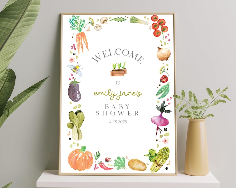 May include: A white baby shower invitation with a green, red, and yellow watercolor border of vegetables and a bee. The text reads "Welcome to Emily Jane's Baby Shower 4.28.2025".