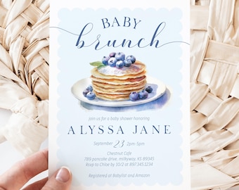 May include: A blue and white baby shower invitation with a watercolor illustration of a stack of pancakes topped with blueberries. The text reads "Baby Brunch" and includes the name "Alyssa Jane", the date "September 23", the time "2pm-5pm", the location "Chestnut Cafe", the address "789 pancake drive, milkyway, KS 89345", the RSVP information "Rsvp to Chloe by 10/2 at 897.345.1234", and the registry information "Registered at Babylist and Amazon".