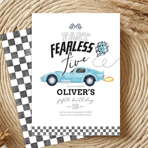 May include: A white invitation card with a racing theme. The card features the text "FAST FEARLESS Five" and a light blue car illustration. It also includes the text "OLIVER'S fifth birthday" and event details.