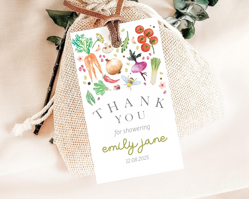 May include: White thank you tag with a watercolor illustration of vegetables, a bee, and flowers. The text reads "Thank You for showering Emily Jane 12.08.2025".