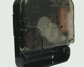 May include: A black plastic quartz clock movement mechanism with a translucent cover. The casing features molded text including Young Town Quartz, Made in Taiwan, No Jewels Unadjusted, and CE. A dark brown gear is visible on the side.