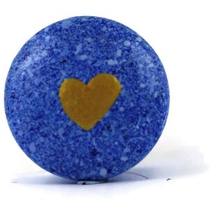 May include: A blue round ornament with a gold heart painted on it.