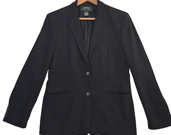 May include: A black blazer featuring a notched lapel, two front buttons, and two side pockets. The interior label reads Lauren Ralph Lauren. The blazer has long sleeves with four small buttons on each cuff and is displayed on a wooden hanger.