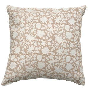 May include: A beige throw pillow with a white floral pattern. The pillow is made of a soft, textured fabric.