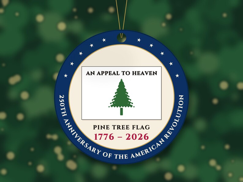 May include: A round, flat ornament featuring a central white rectangle with a green pine tree graphic and the text AN APPEAL TO HEAVEN. Below is PINE TREE FLAG and 1776-2026. The blue border displays 250TH ANNIVERSARY OF THE AMERICAN REVOLUTION.