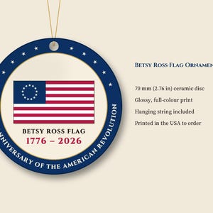 May include: A round 70 mm ceramic disc ornament featuring the Betsy Ross flag with 13 stars in a circle. The blue border displays the text 250TH ANNIVERSARY OF THE AMERICAN REVOLUTION. Below the flag, the text reads BETSY ROSS FLAG 1776 - 2026.