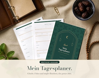 May include: A daily planner with a dark green cover featuring a gold arch, crescent moon, and lantern icons. The cover text reads Mein Tagesplaner. Included are white interior pages with printed lines and headers for daily and weekly scheduling.