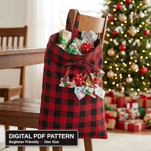 May include: A red and black buffalo check fabric gift bag featuring a top handle, a front pocket, and a drawstring closure. The bag is filled with various wrapped gifts and red bows. The text on the image reads: DIGITAL PDF PATTERN Beginner Friendly One Size.