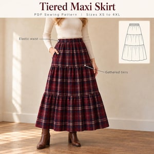 May include: A tiered maxi skirt PDF sewing pattern for sizes XS to 4XL. The skirt features a red and navy blue plaid pattern, an elastic waist, and gathered tiers. An inset diagram shows the skirt structure with labels for elastic waist and gathered tiers.