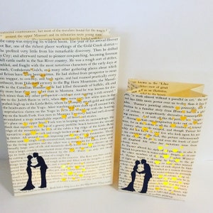 May include: Two book covers with a silhouette of a couple dancing. The covers are decorated with gold glitter and text. The text on the left cover reads "Both had a deep love for the Old West."